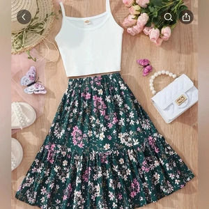 Sleeveless white crop cami top and floral‎ ruffled skirt